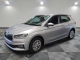 a silver car is parked in a room with checkered flooring