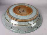 a blue and brown bowl sitting on top of a white table