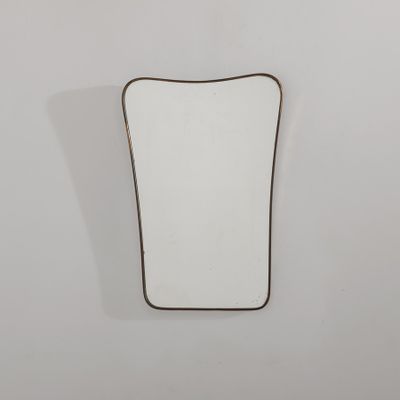 un petit miroir accroché au mur dans une salle de bains