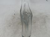 a glass vase that is sitting on the floor
