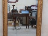 a mirror that is sitting on the floor in front of a wall