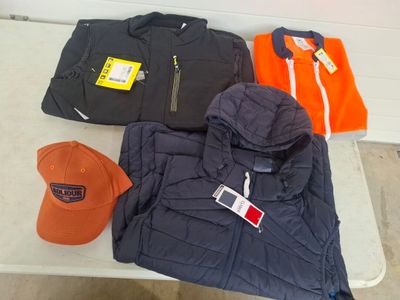 three jackets, a hat, and a baseball cap on a table