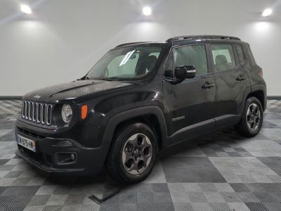 the black jeep is parked in the garage on a checkered floor