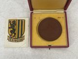 an image of a medal in a red box with a gold medal in it