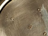 a close up of a silver plate with a sticker on it