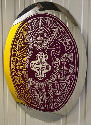 a picture of a red and yellow circular sign on a wall