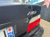 a black car with a blue star on the back of it