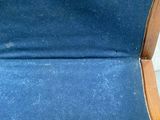 a person holding a piece of blue fabric in a chair