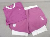 purple and white shorts with white letters on them on a couch