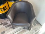 a chair that is next to a barrel of oil