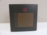 a picture of a black box with a red dot on it