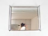 a person taking a picture of themselves in a mirror