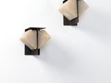 pair of black and white wooden wall sconces with a white background