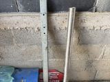 two pieces of metal on the ground next to a wall