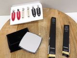a wooden table with a lot of makeup items on it