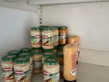 many jars of peanut butter on a shelf in a store