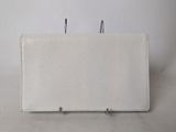 a white piece of cloth with two metal hooks on it