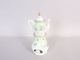 a small tea pot sitting on top of a white table