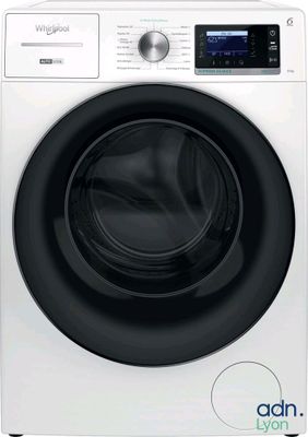 a white washing machine sitting on top of a white counter