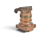 a small metal object with a hammer on top of it