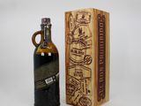 a bottle of liquor sitting next to a wooden box on a table