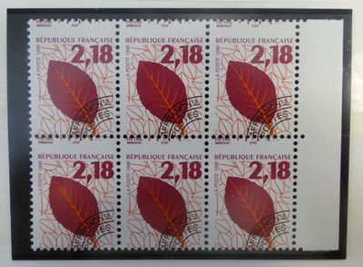 four stamps with red leaves on them on a white surface