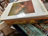 books stacked on top of each other on a table in a room