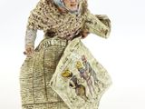 figurine of a woman holding a basket and a book