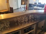 bottles and glasses are lined up on a bar in a restaurant