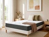 an image of a bedroom with a bed and a rug on the floor