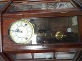 a glass case with a clock inside of it