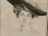 an old picture of a woman with a large hat on top of her head