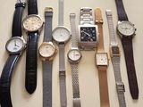 a lot of watches that are sitting on a table