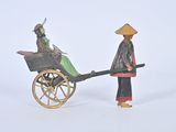 a figurine of a man pulling a cart with a horse