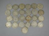 some silver coins are arranged in a heart shape on a table