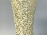 a white vase that is sitting on a table