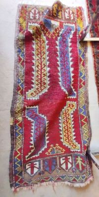 two pieces of red and blue rugs on the floor