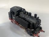 a toy train on a white surface with a white background