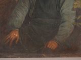 portrait of a man in a green shirt and blue overalls