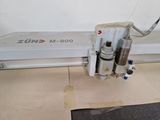 a machine that is cutting a piece of paper