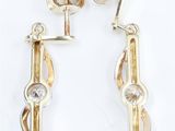 pair of gold and diamond earrings on a white background