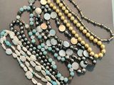 a lot of necklaces that are on display on a table