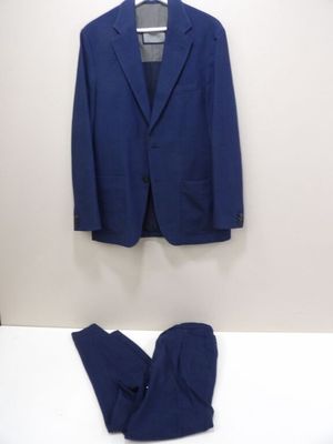 a blue suit and a pair of pants sitting on a bed