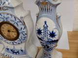 two blue and white vases sitting on a wooden table