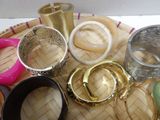 many different types of bracelets and bangles on a tray