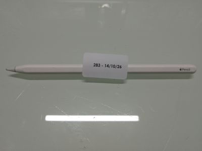 a white pen with a sticker on it sitting on a table