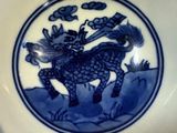 a blue and white plate with a picture of a horse on it