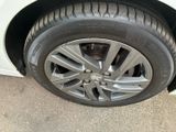 a close up of a tire on a white car