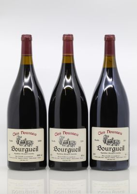 three bottles of red wine are lined up on a white surface