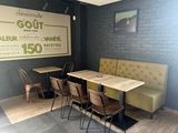 tables and chairs in a room with a large sign on the wall